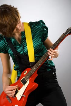 Close-up of a female guitarist playing a guitar