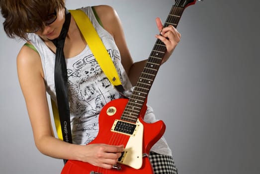 Close-up of a female guitarist playing a guitar