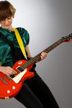 Close-up of a female guitarist playing a guitar