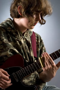 Close-up of a female guitarist playing a guitar
