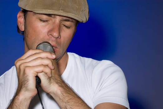 Close-up of a young man singing into a microphone