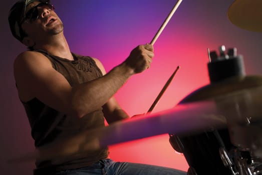 Side profile of a male drummer playing drums