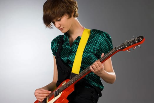 Close-up of a female guitarist playing a guitar