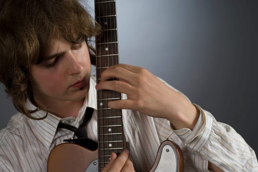 Close-up of a male guitarist playing a guitar