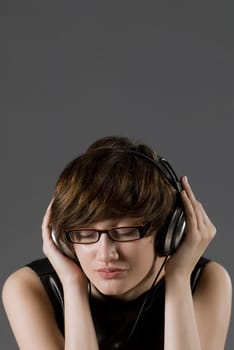 Close-up of a young woman listening to music