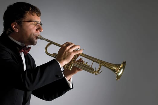 Side profile of a musician playing a trumpet