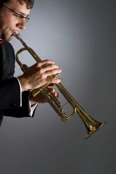 Side profile of a musician playing a trumpet