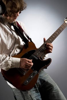 Close-up of a male guitarist playing a guitar