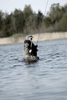 Side profile of a mature man fishing in the river