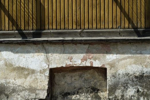 Close-up of a railing on a weathered wall