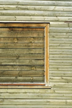 Close-up of a window on a wooden wall