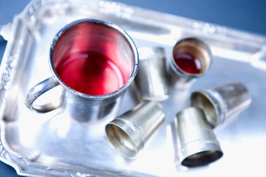 High angle view of a mug of red wine and glasses on a tray