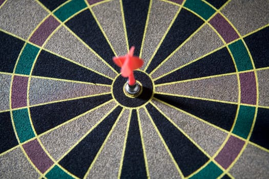Close-up of a dart in the bulls-eye of a dart board