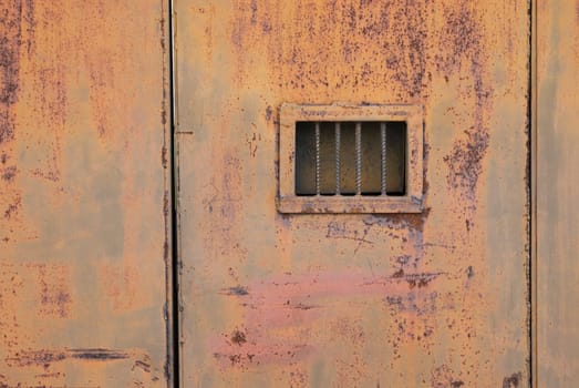 Close-up of a window on a metal door