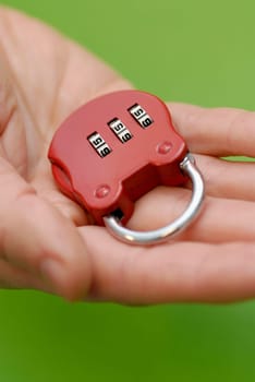 Close-up of a personŽs hand holding a combination lock