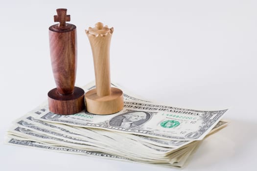 Chess pieces on stack of US paper currency