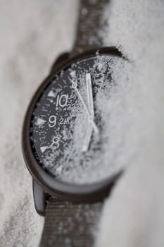 Close-up of a wristwatch in sand