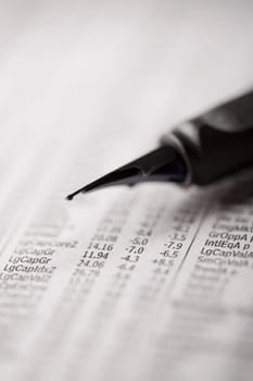 Close_up of a fountain pen on a financial newspaper