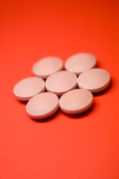 Close_up of pills on a red background