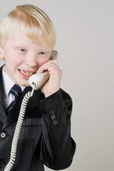 Close_up of a boy talking on the telephone