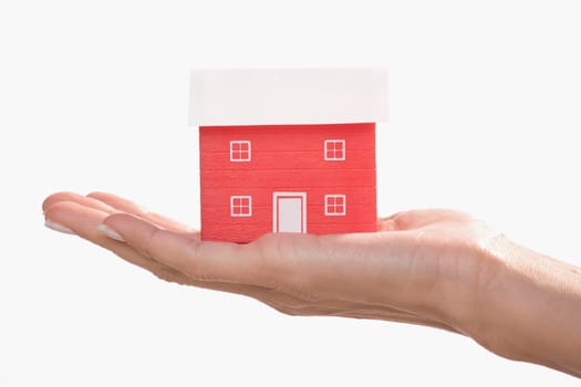 Model home on a palm of a woman