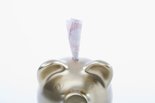 Paper currency sticking out of a piggy bank