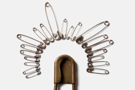 Close-up of safety pins arranged in a circle