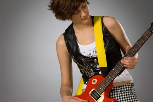 Close-up of a female guitarist playing a guitar