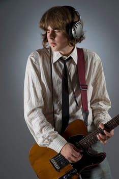 Close-up of a male guitarist playing a guitar