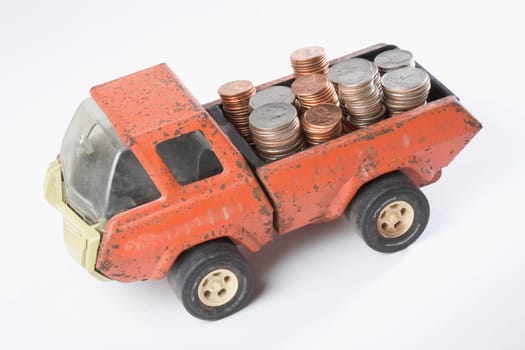 High angle view of a toy truck loading stacks of coins