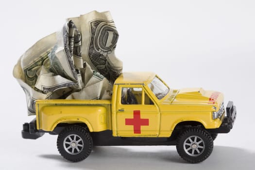 Close_up of toy pick_up truck carrying US dollar bills