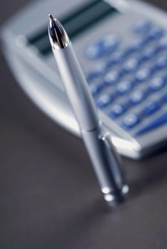 Close-up of a pen with a calculator
