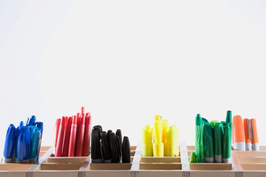 Close-up of colored pens in pen stands