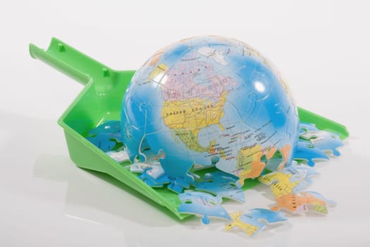 Close_up of a broken globe on a dustpan
