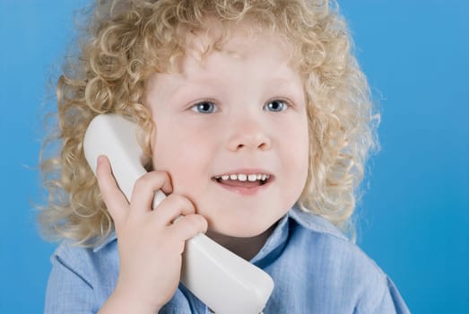 Close_up of a boy talking on the telephone