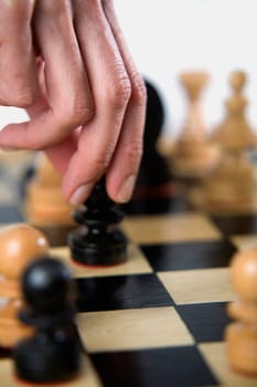 Close-up of a personŽs finger holding a chess piece