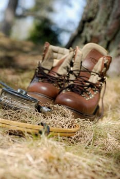 Wading boots with a fishing net and a fishing reel