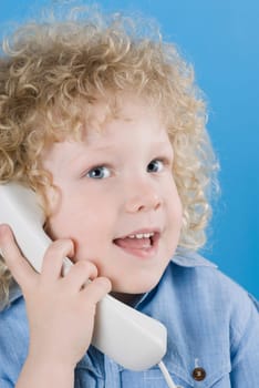 Close_up of a boy talking on the telephone
