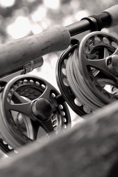 Close-up of two fishing reels and a fishing rod