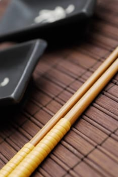 Close-up of two chopsticks on a mat