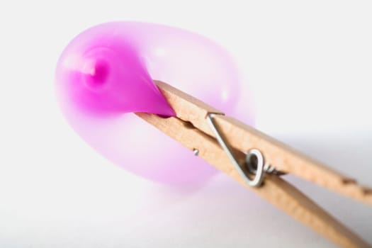 Close-up of a condom in a clothespin