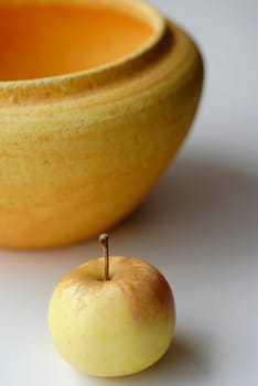 Close-up of an apple with a bowl