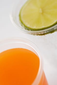 Close-up of a glass of orange juice and a glass of lemonade