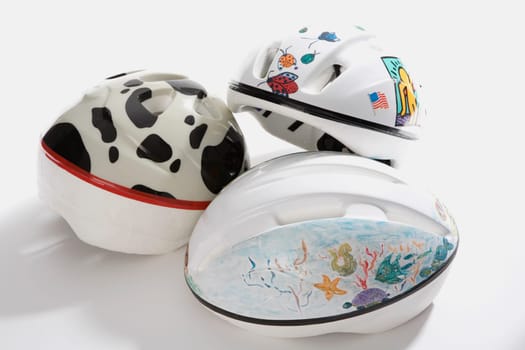 Close-up of three cycling helmets