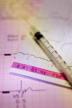 Close_up of a syringe on a medical report
