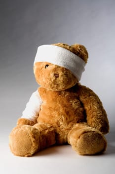 Close-up of a teddy bear with a bandage