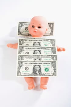 US one dollar bills on a doll