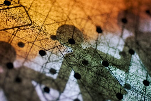 Close_up of a circuit board with paper chain dolls shadow on it