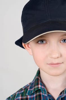 Close_up of a boy wearing a cap