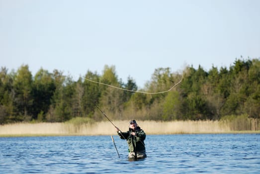 Mature man fishing in the river